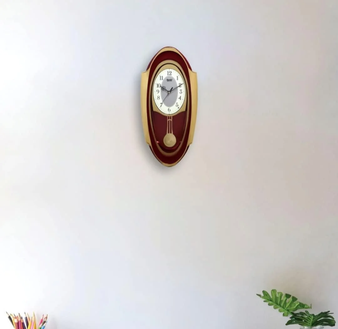 ساعت دیواری پاندول دار موزیکال آجانتا مدل 1627 قرمز – موتور کوارتز | ملودی های ساعتی و پاندول متحرک | طراحی بیضی شکل زیبا | 50.7 x 24.9 سانتی متر ساعت دیواری پاندول دار موزیکال آجانتا مدل 1627 قرمز – موتور کوارتز | ملودی های ساعتی و پاندول متحرک | طراحی بیضی شکل زیبا | 50.7 x 24.9 سانتی متر