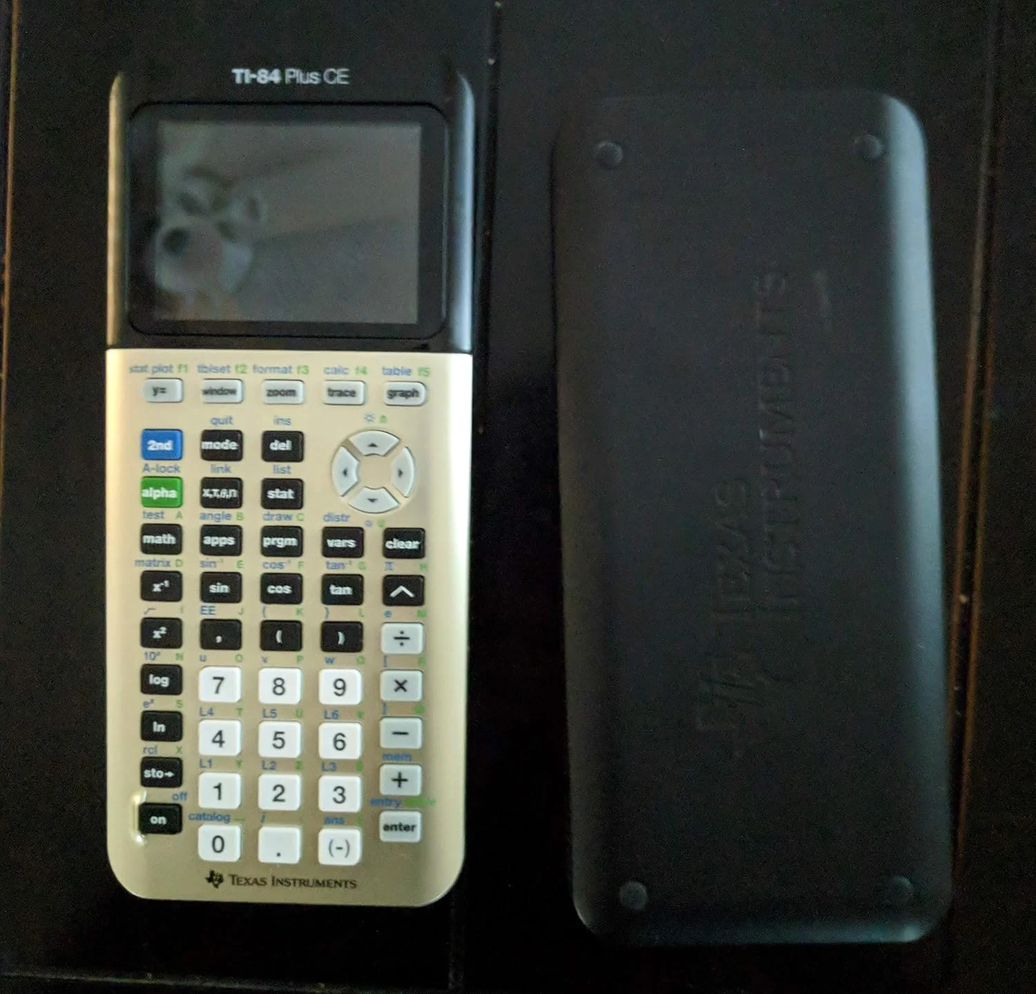 ماشین حساب گرافیکی تگزاس اینسترومنتس TI-84 PLUS CE به همراه دفترچه راهنما طلایی