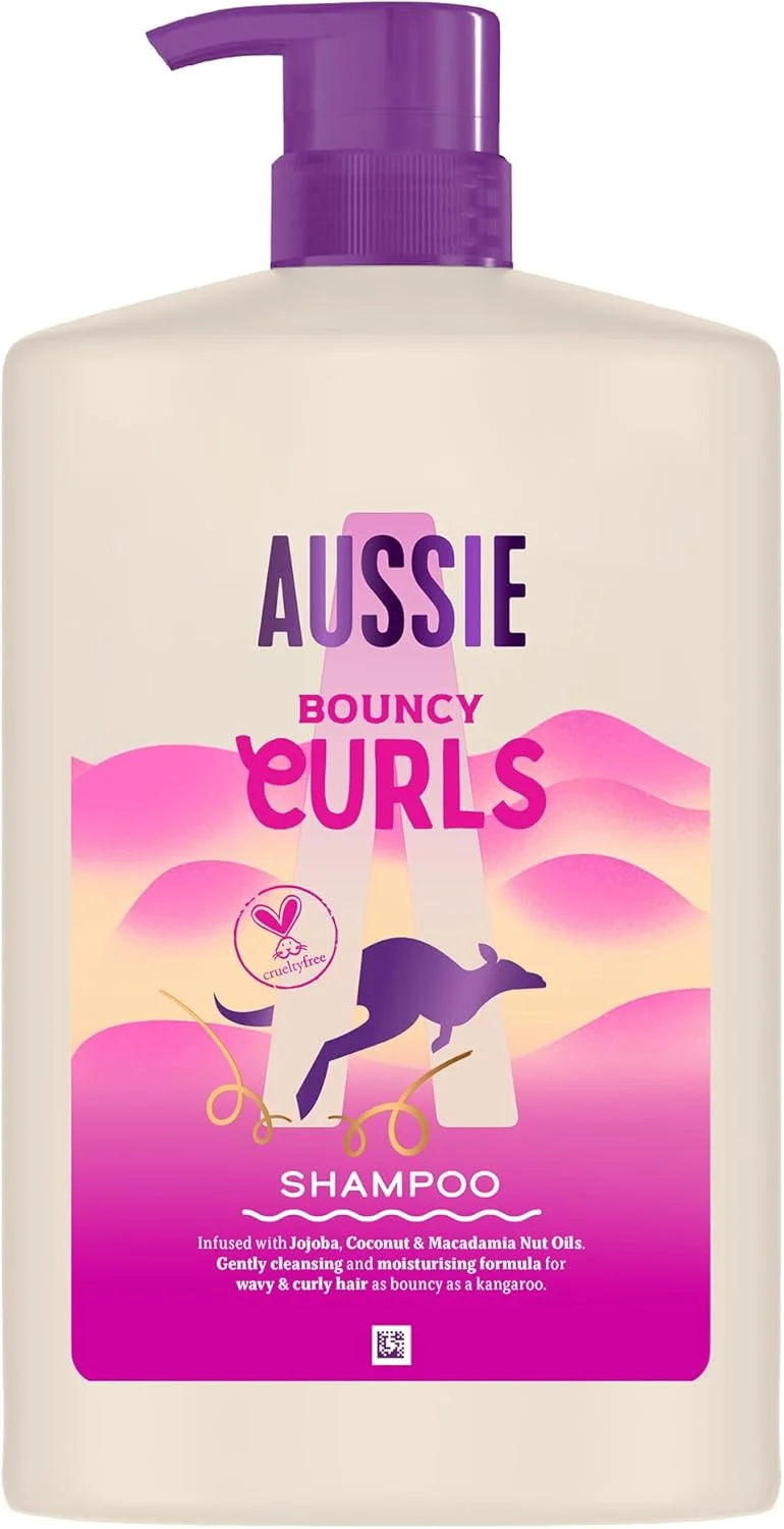 شامپو موی فر Aussie مدل Bouncy Curls حجم 1000 میلی لیتر، پاک کننده ملایم و آبرسان برای موهای موج دار و فر، حاوی روغن جوجوبا، نارگیل و ماکادمیا استرالیایی، فاقد سیلیکون، وگان و بدون تست حیوانی