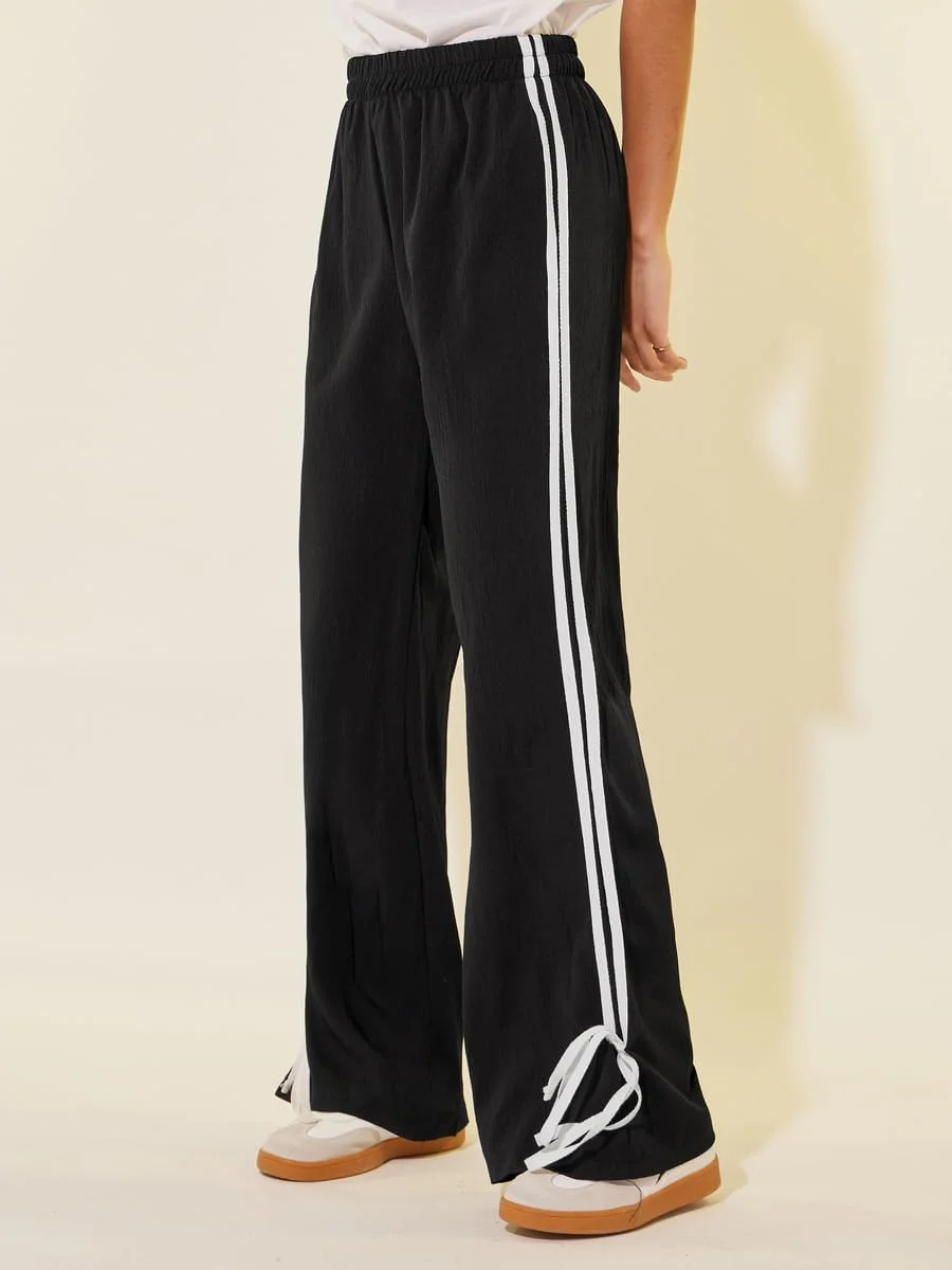 شلوار زنانه استایلی مدل 7016953101 با جزئیات گره پروانه‌ای و پاچه گشاد