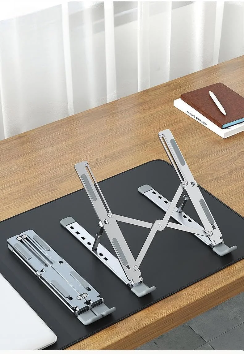 پایه تاشو لپ تاپ آلیاژ آلومینیوم، پایه محکم کامپیوتر نوت بوک برای میز، نگهدارنده قابل تنظیم و قابل حمل ضد لغزش برای لپ تاپ ها و تبلت های 10-15.6 اینچی - نقره ای پایه تاشو لپ تاپ آلیاژ آلومینیوم، پایه محکم کامپیوتر نوت بوک برای میز، نگهدارنده قابل تنظیم و قابل حمل ضد لغزش برای لپ تاپ ها و تبلت های 10-15.6 اینچی - نقره ای