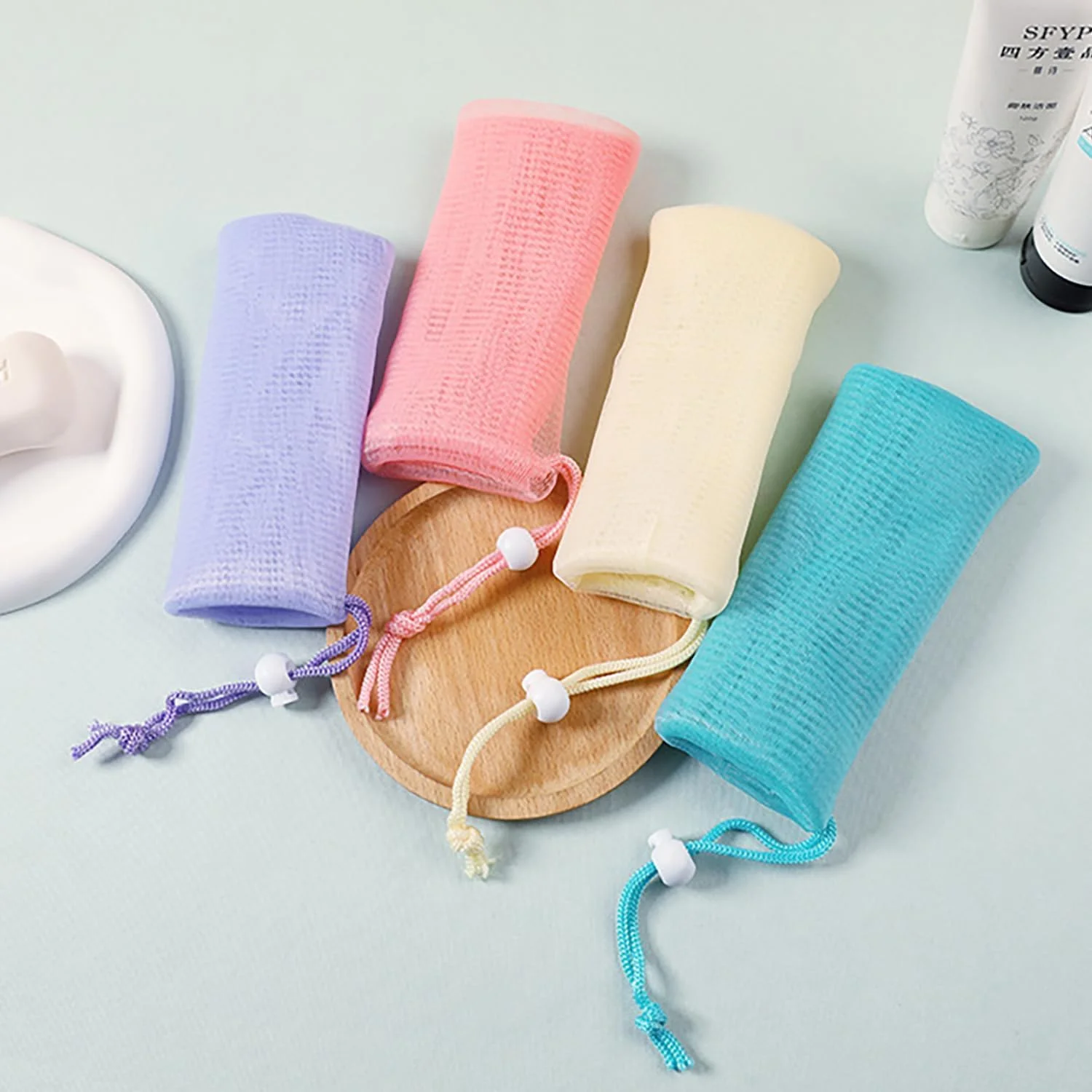 بسته 10 عددی کیسه توری صابون لایه بردار با بند کشی - کیسه های صابون فوم قابل استفاده مجدد برای تمیز کردن ملایم بدن و صورت، تورهای صابون حمام با پاکسازی عمیق، اسکرابر حمام سازگار با محیط زیست، شامل رنگ های تصادفی