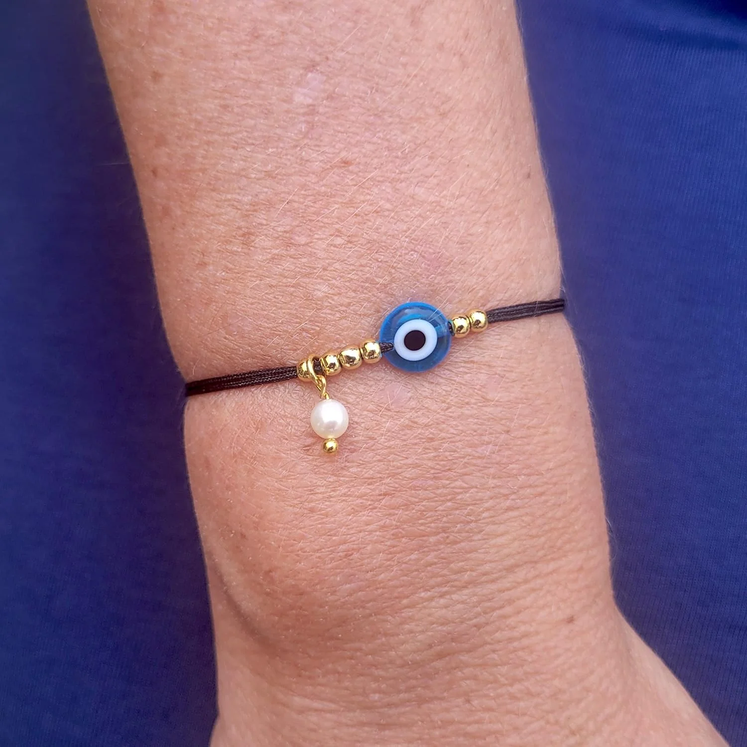 دستبند نخی الوان با طرح چشم نظر و یک مروارید کوچک - EE3982XG