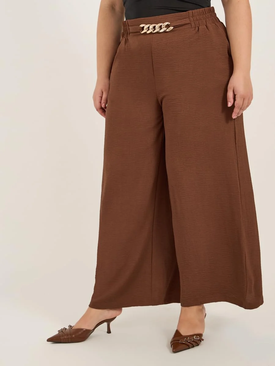 شلوار زنانه سایز بزرگ استایلی با بافت پهن و جزئیات سگک زنجیری