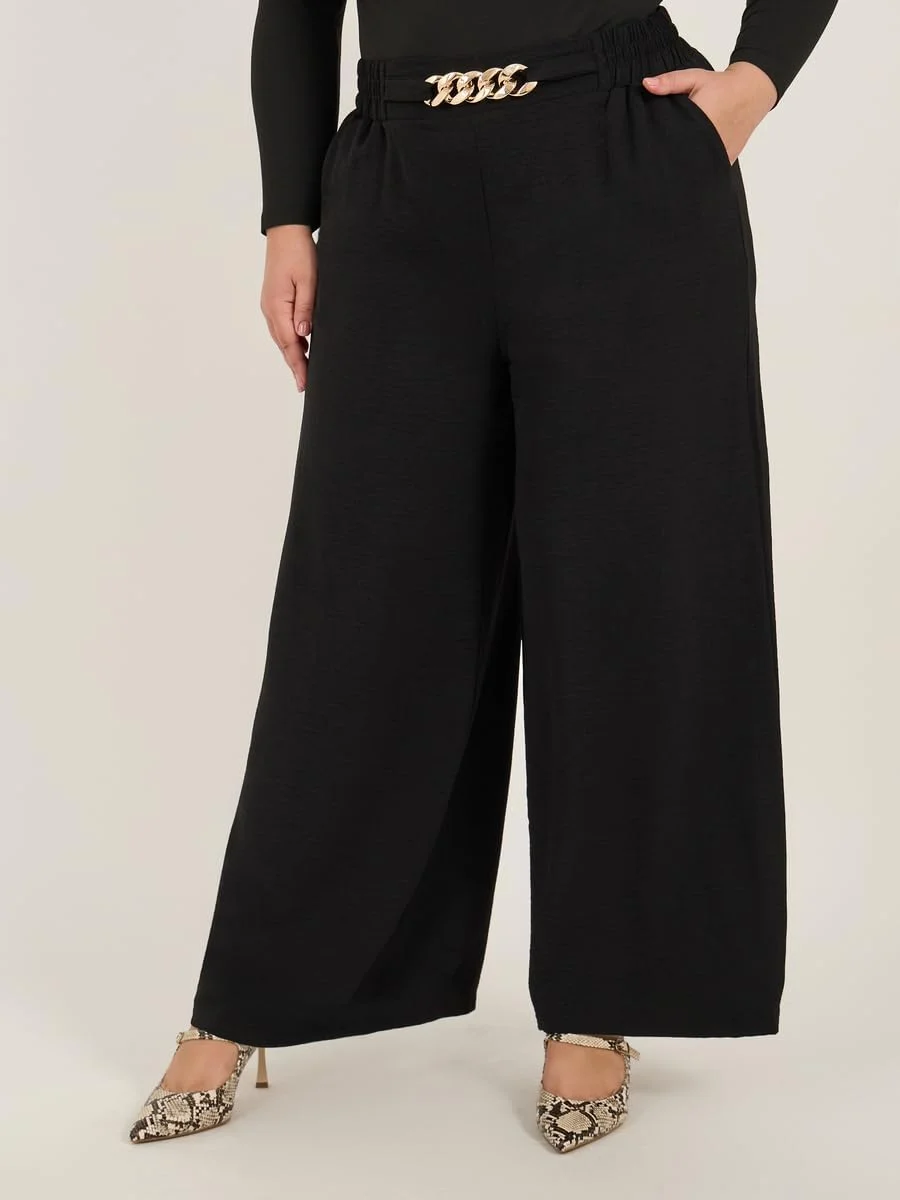 شلوار زنانه سایز بزرگ استایلی با بافت و پاچه گشاد به همراه سگک زنجیری