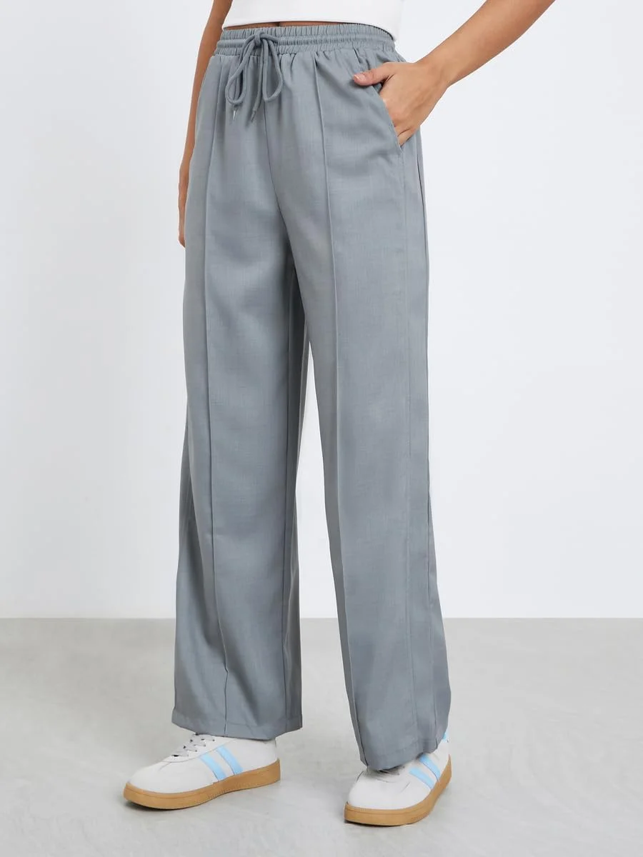 شلوار زنانه استایلی خاکستری طرح کتان پاچه گشاد با پیلی