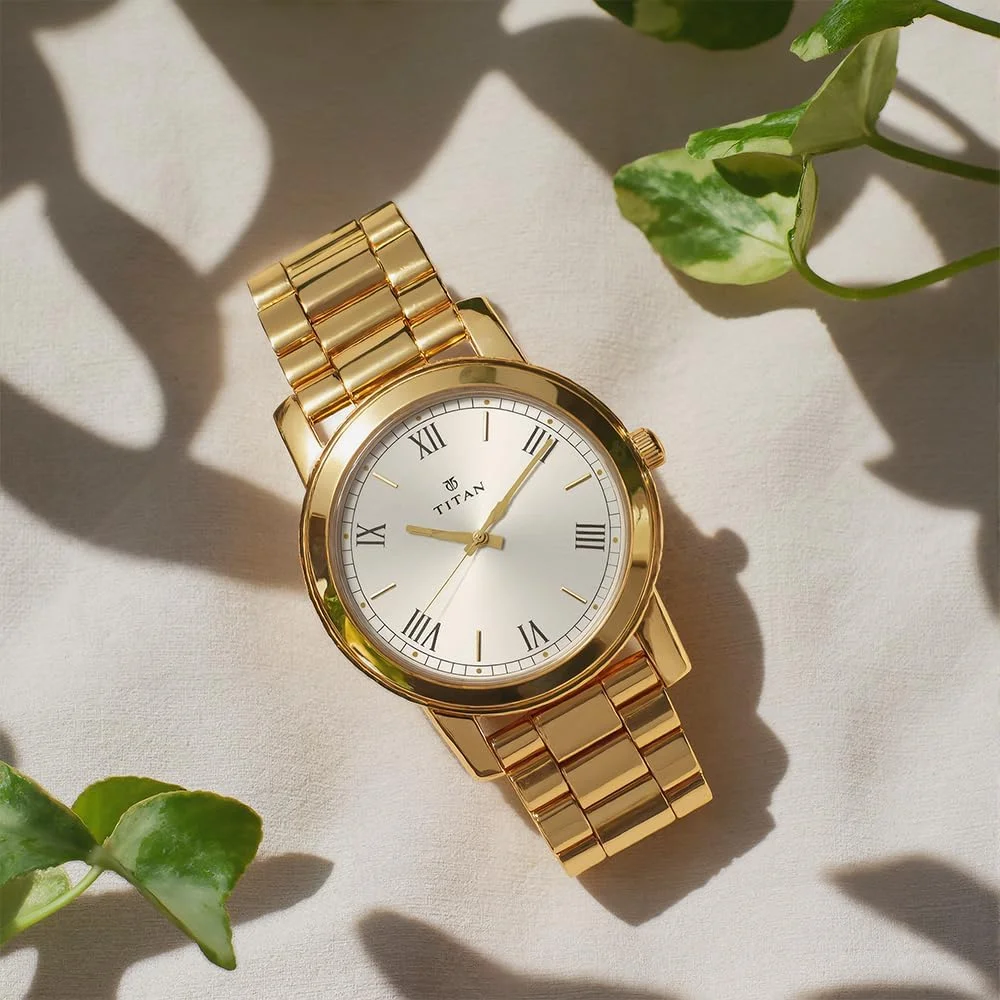 ساعت مچی مردانه تیتان آنالوگ صفحه نقره ای مدل NL1644YM01/NP1644YM01 بند استیل طلایی