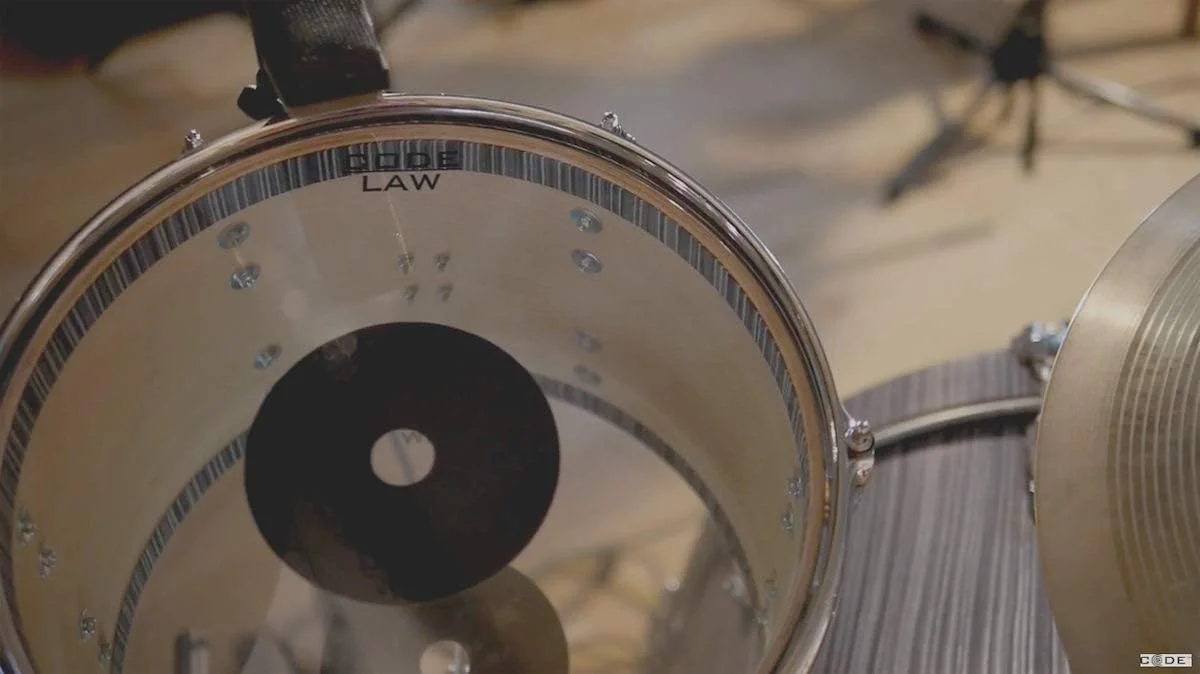 پوست درام شفاف 10 اینچی سری Code Law همراه با دونات پوست درام شفاف 10 اینچی سری Code Law همراه با دونات