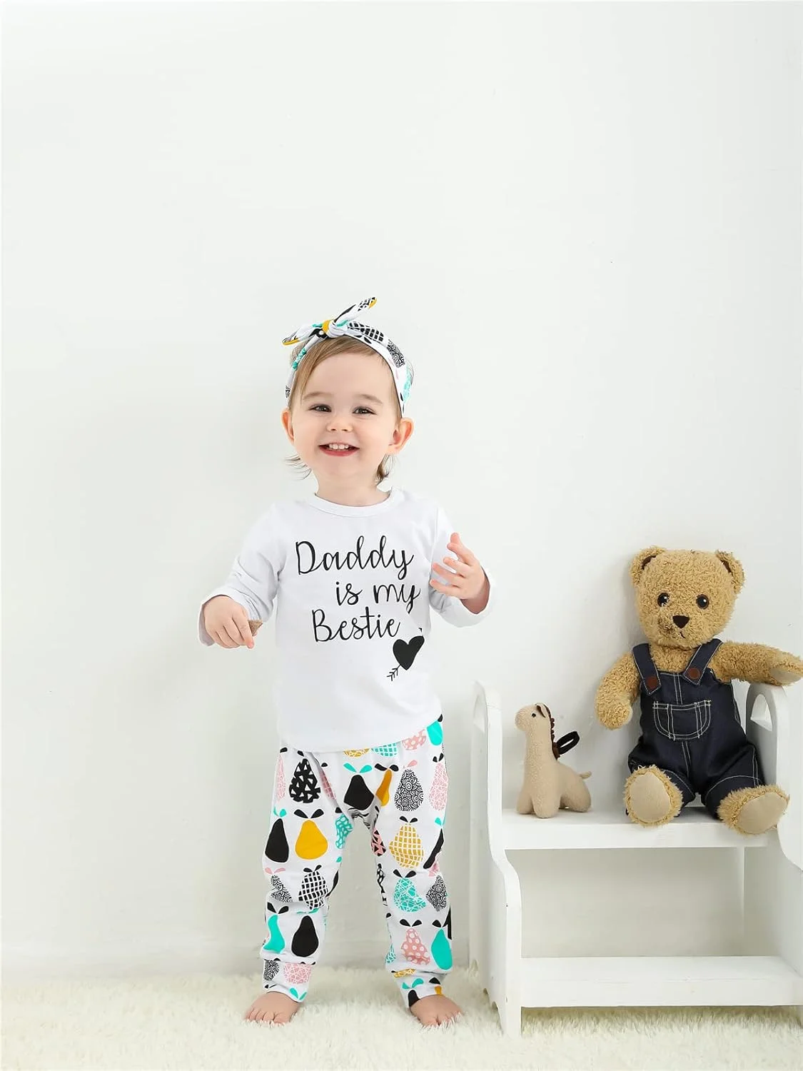 ست لباس 3 تکه دخترانه KuKitty شامل تیشرت آستین بلند، شلوار طرح گل و تل سر ست لباس 3 تکه دخترانه KuKitty شامل تیشرت آستین بلند، شلوار طرح گل و تل سر