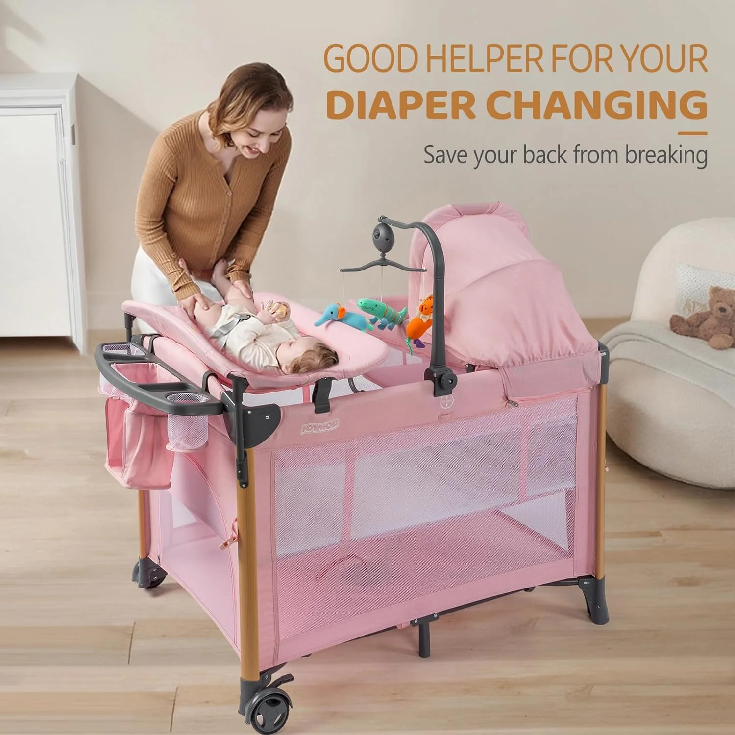 سبد حمل نوزاد JOYMOR مدل 7 در 1 به همراه میز تعویض، سبد حمل نوزاد، تخت صورتی با تشک، ملحفه، سایبان، قفسه نگهداری و آویز اسباب بازی