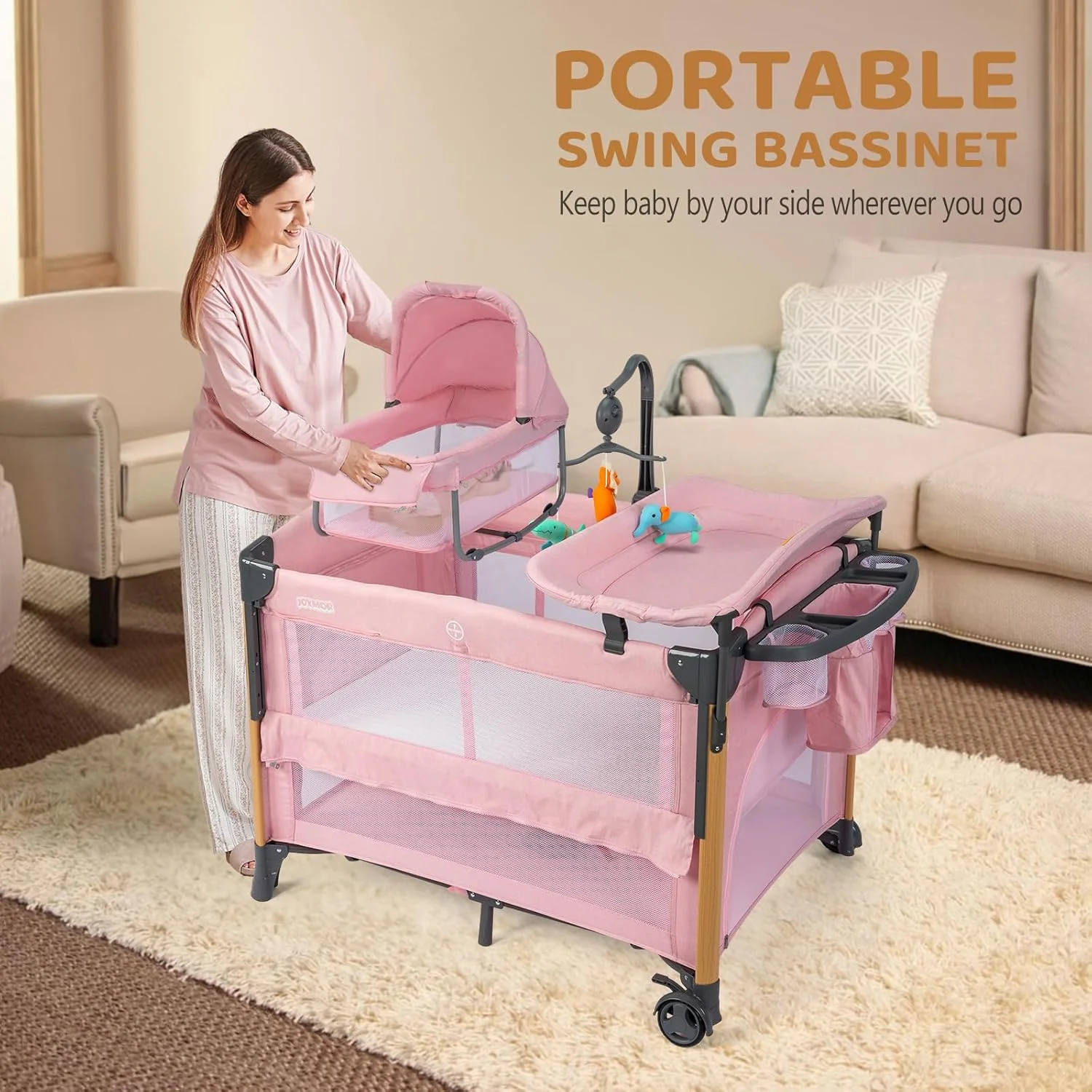 سبد حمل نوزاد JOYMOR مدل 7 در 1 به همراه میز تعویض، سبد حمل نوزاد، تخت صورتی با تشک، ملحفه، سایبان، قفسه نگهداری و آویز اسباب بازی