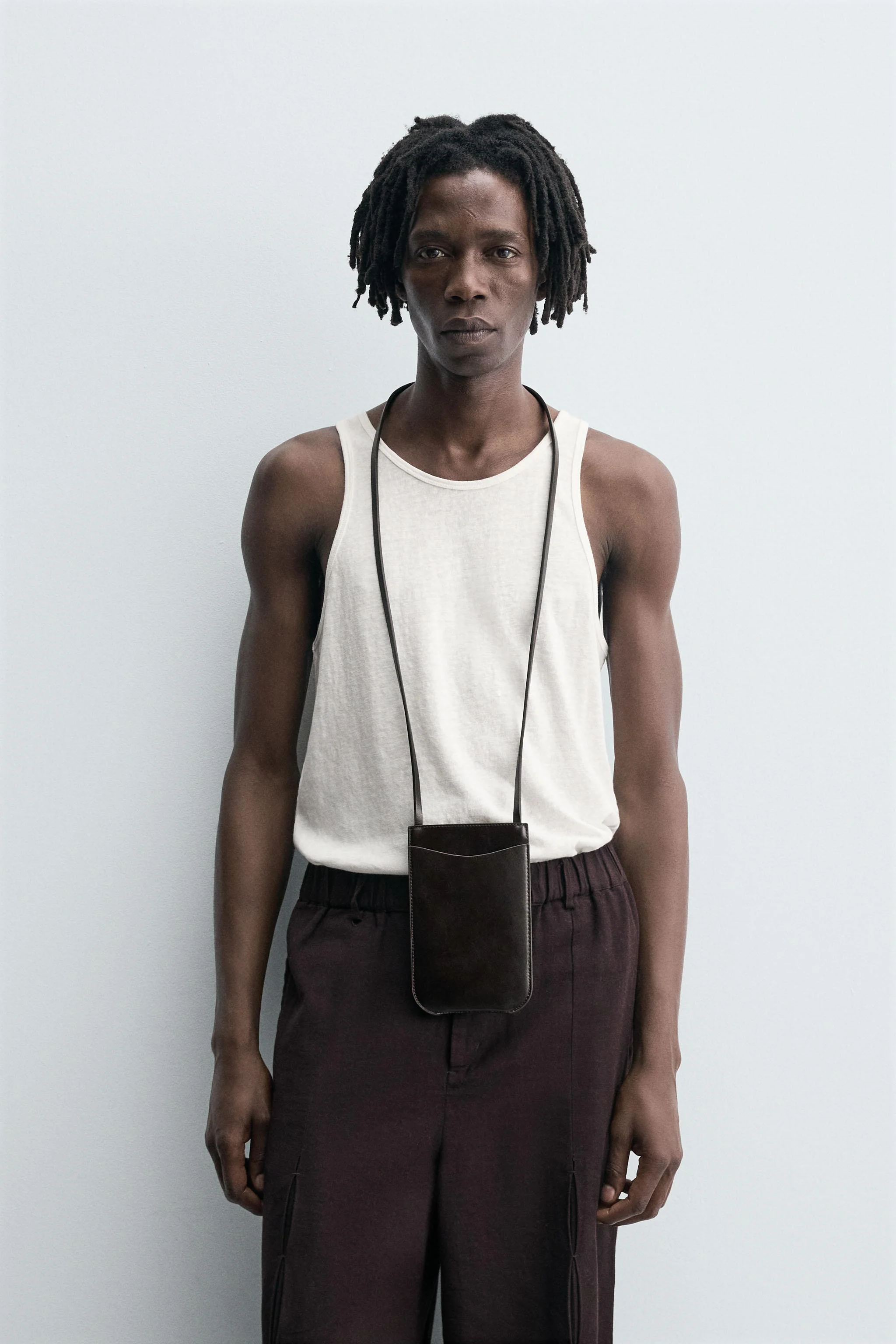 تاپ رکابی جذب و باریک تهیه شده از پارچه سبک وزن با الیاف پنبه. دارای یقه گرد باز و طراحی بدون آستین.