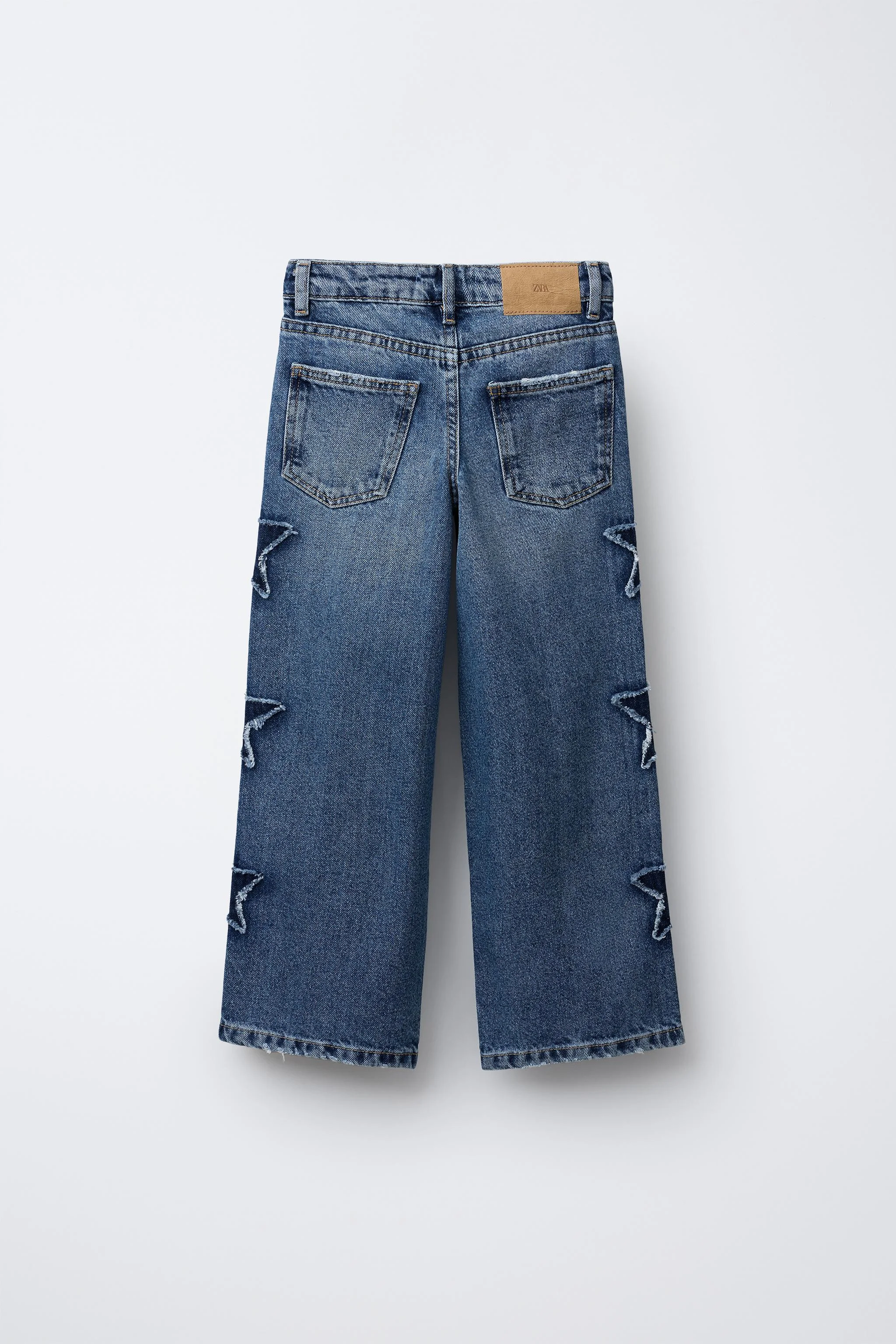 شلوار جین پاچه گشاد با تکه دوزی های ستاره